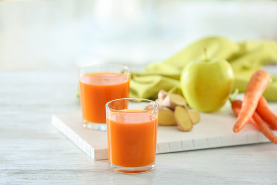 Glasses of carrot juice on light table