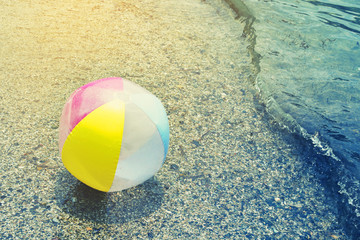 Children's bright ball on the seashore, beach rest