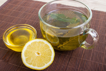 Herbal tea with honey and lemonon the wooden background