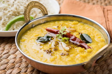 Indian popular food Dal fry or traditional Dal Tadka Curry served with jeera rice, isolated over white background, selective focus - obrazy, fototapety, plakaty