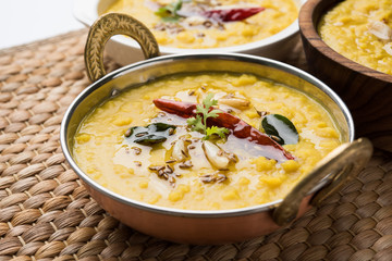 Indian popular food Dal fry or traditional Dal Tadka Curry served in 3 different bowls and placed together, closeup view over white background, selective focus - obrazy, fototapety, plakaty
