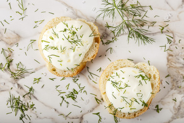 Sesame bagel with cream cheese, dill and salt