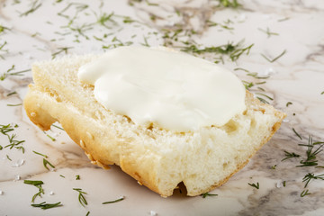 Sesame bagel with cream cheese on table