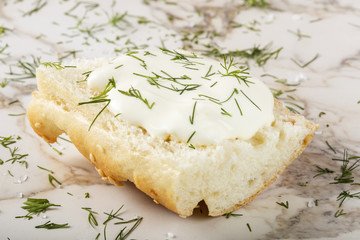 Close-up of Sesame bagel with cream cheese and dill