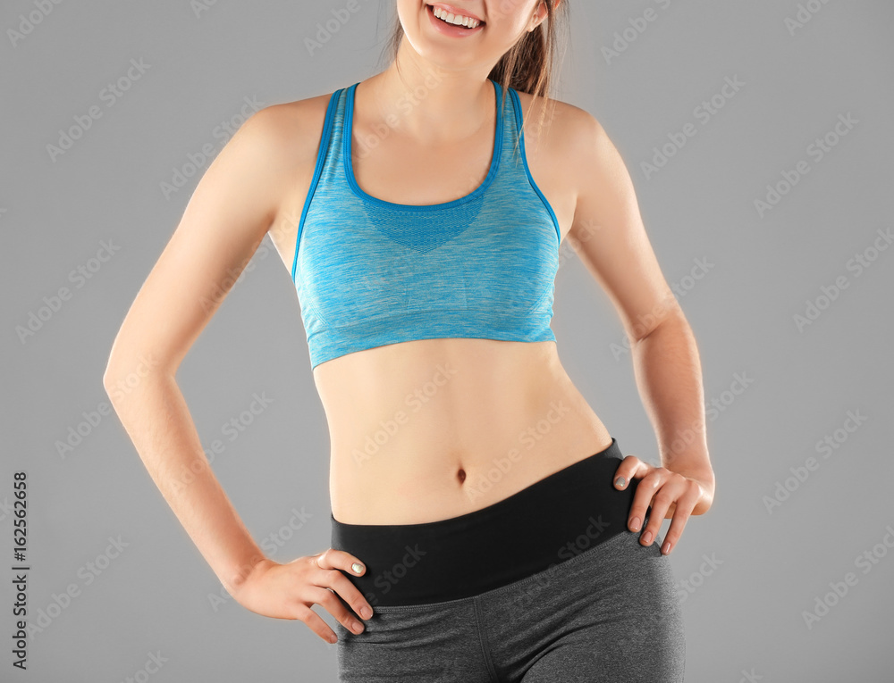 Canvas Prints Beautiful young woman on grey background. Diet concept