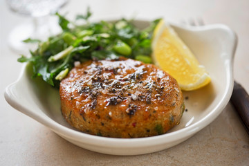 Thai style fishcakes with spicy soy glaze, green salad and lemon wedge 