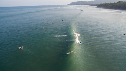 Aerial view of a surfer on a wave in Jaco, Costa Rica