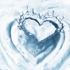 Fototapeta na wymiar Heart from water splash with bubbles on blue water background