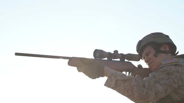 Military sniper takes aim at the optical sight. Airsoft