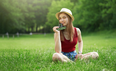 cute girl with camera on grass summer