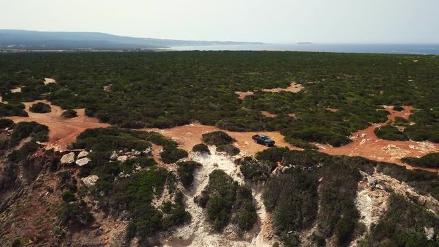 Aerial view car traveling on the impassable mountain road