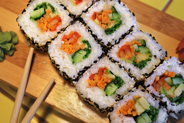 Sushi on a wooden board.