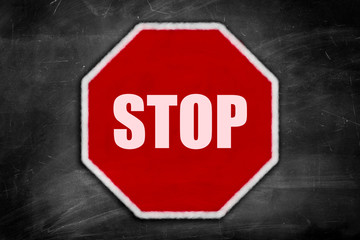 stop sign on a black chalkboard