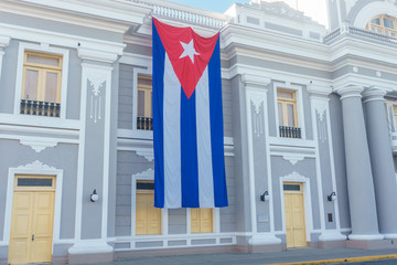 Cuban flag in colonial facade, national day celebration