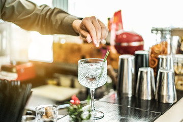 Bartender preparing cocktail with gin , rosemary and pink pepper inside bar - Soft focus on top crystal glass - Lifestyle , nightlife , drinking and entertainment concept - Contrast retro filter - obrazy, fototapety, plakaty
