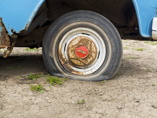Fototapeta na wymiar Flat Tire on an Old Truck: 