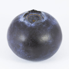 One blueberry isolated on white background. Macro photography with natural colors. Clipping path.