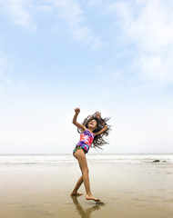 Fototapeta premium Happy girl dancing at the beach.