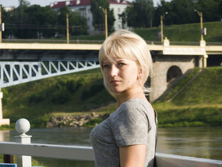 Young girl stands near the river