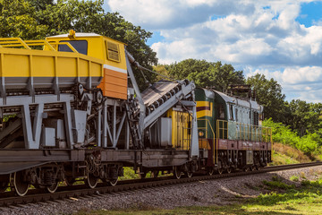 Fototapeta na wymiar Diesel shunting locomotive with a wagon for construction and repair of railway tracks