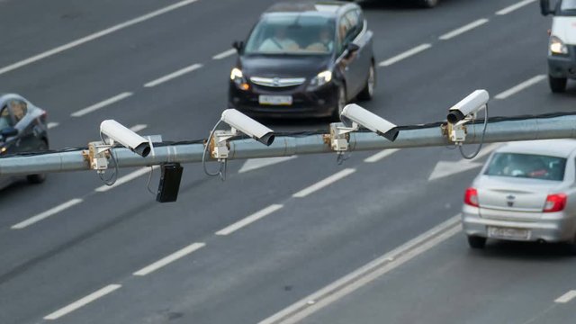 Closeup of four traffic security camera surveillance CCTV on the road in the big city. Timelapse