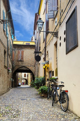 Bicycle parked near the wall of an ancient house in an Old Town of Ferrara, Italy