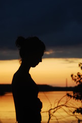 Fototapeta premium Girl silhouette by the river