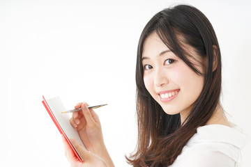 Young woman taking a note