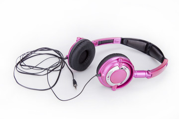 Pretty pink headphones on a white surface. Pink headphones isolated on white background.