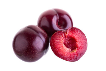 ripe fresh plum with half and slice isolated on white background