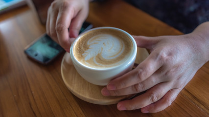 Hand Holding Hot Latte Coffee