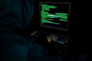 Hacker stealing data from a computer.