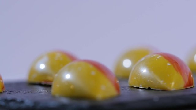 close up of two caramel candies on white background. Salted caramel pieces. Row of caramel candies on white background