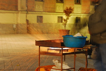 Street seller frying chestnuts on the street