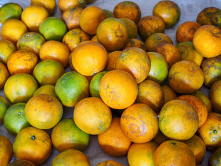 Heap of fresh striped oranges on sack, a lot of striped oranges. fresh Orange from the orchard