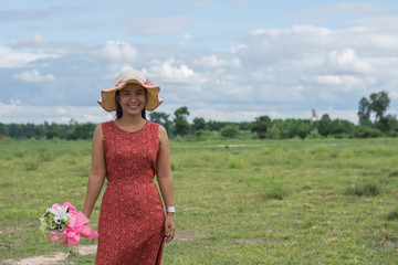 Young beauty woman relaxing in green field. Enjoy with mature, Women lifestyle concept.