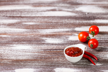 Tomato sauce and ingredients on a wooden background. Selective focus. Copy space