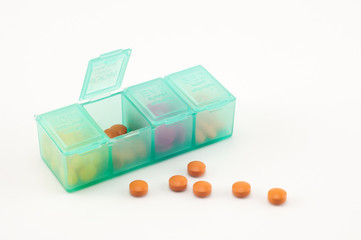 open pill box and tiny pills