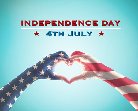 Independence day 4th of July  with United States of America USA flag pattern on people hands in heart shape on blue sky