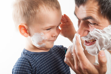 Dad teaches his son to shave.