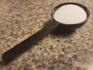 black spoon with sugar