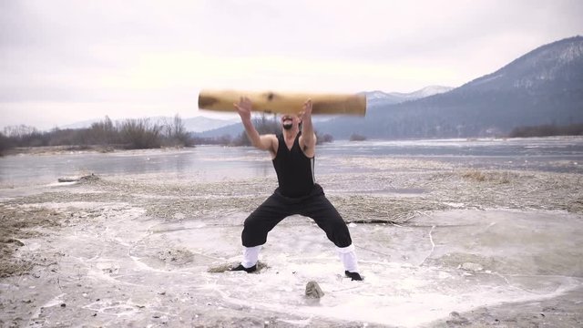 Training with heavy log in winter icy lake 4K