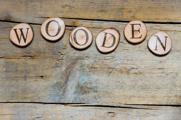 wooden slices on wooden table, word wooden