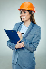 Smiling businesswoman builder holding clipboard with contract