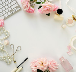 Beauty blog concept. Female make up accessories and bouquet of pink roses on white background. Flat...