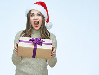 Beautiful surprised woman holding gift box.