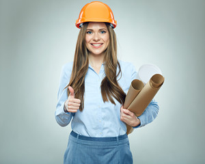 Smiling business woman builder holding rolled up technical drawing