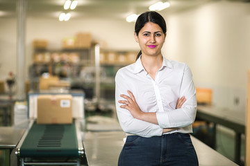 latina worker portrait in packaging plant.