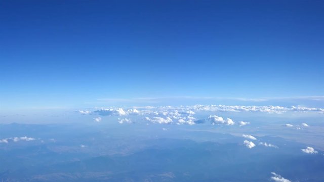  Aerial shot above the clouds of mountains in 4K
