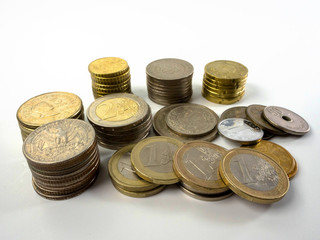 Stack of various coin types on white background as financial concepts.